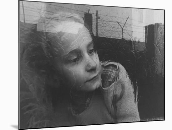 Girl Gazing Pensively Through Pane of Her Apartment Window, Grimly Reflects Image of Berlin Wall-Paul Schutzer-Mounted Photographic Print