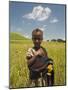 Girl Holding Yellow Meskel Flowers in a Fertile Green Wheat Field after the Rains-Gavin Hellier-Mounted Photographic Print