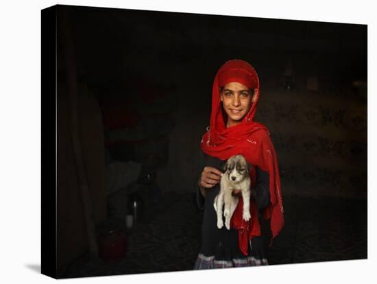 Girl Holds a Puppy as the Sun Sets over Kabul's Impoverished Teppe Maranjan Neighborhood-null-Stretched Canvas
