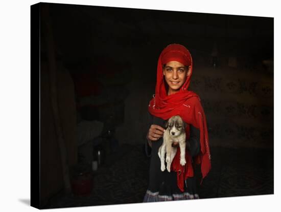 Girl Holds a Puppy as the Sun Sets over Kabul's Impoverished Teppe Maranjan Neighborhood-null-Stretched Canvas