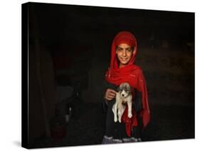 Girl Holds a Puppy as the Sun Sets over Kabul's Impoverished Teppe Maranjan Neighborhood-null-Stretched Canvas