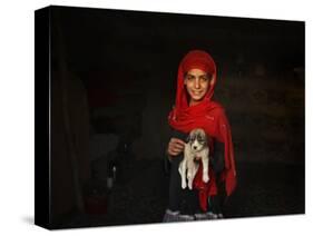 Girl Holds a Puppy as the Sun Sets over Kabul's Impoverished Teppe Maranjan Neighborhood-null-Stretched Canvas