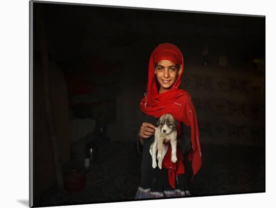 Girl Holds a Puppy as the Sun Sets over Kabul's Impoverished Teppe Maranjan Neighborhood-null-Mounted Photographic Print