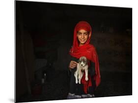 Girl Holds a Puppy as the Sun Sets over Kabul's Impoverished Teppe Maranjan Neighborhood-null-Mounted Photographic Print
