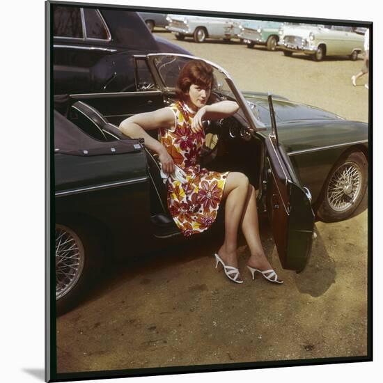 Girl in a Classic Racing Green "MGB" Sports Car-null-Mounted Art Print