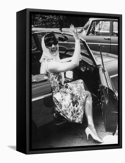 Girl in a Flower Print Dress, High Heels, Headscarf and Sunglasses Steps out of a Convertible Car-null-Framed Stretched Canvas