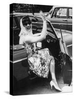 Girl in a Flower Print Dress, High Heels, Headscarf and Sunglasses Steps out of a Convertible Car-null-Stretched Canvas