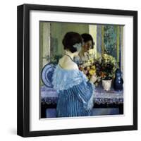 Girl in Blue Arranging Flowers, c1915-Frederick Carl Frieseke-Framed Premium Giclee Print