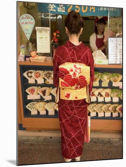 Girl in Kimono, Yukata Buying Crepe, Kyoto City, Honshu, Japan-Christian Kober-Mounted Photographic Print