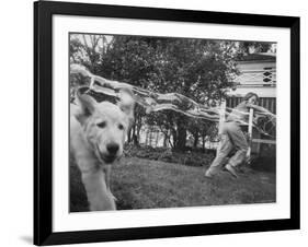 Girl Making Huge Bubbles with Soapy Solution and Large Ring in Yard-Stan Wayman-Framed Photographic Print