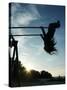 Girl Playing High on Swings at Sunset on Vosu Beach, Located in Lahemaa National Park-Christian Kober-Stretched Canvas