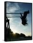 Girl Playing High on Swings at Sunset on Vosu Beach, Located in Lahemaa National Park-Christian Kober-Framed Stretched Canvas