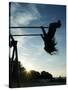 Girl Playing High on Swings at Sunset on Vosu Beach, Located in Lahemaa National Park-Christian Kober-Stretched Canvas