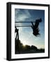 Girl Playing High on Swings at Sunset on Vosu Beach, Located in Lahemaa National Park-Christian Kober-Framed Photographic Print