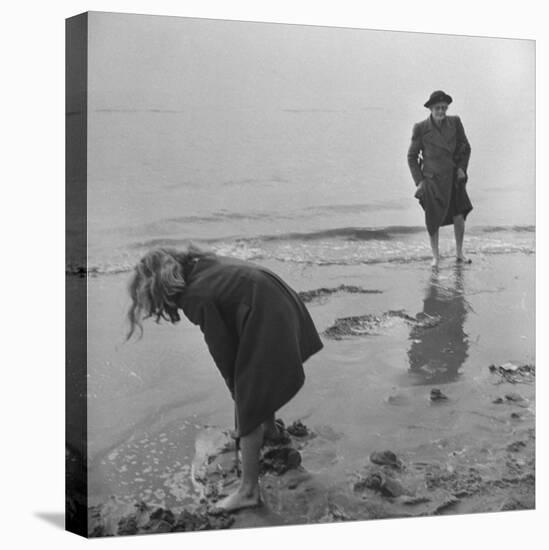 Girl Playing in the Sand while an Older Woman Gets Her Feet Wet in the Ocean at Blackpool Beach-Ian Smith-Stretched Canvas