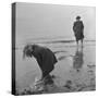 Girl Playing in the Sand while an Older Woman Gets Her Feet Wet in the Ocean at Blackpool Beach-Ian Smith-Stretched Canvas