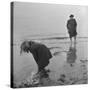 Girl Playing in the Sand while an Older Woman Gets Her Feet Wet in the Ocean at Blackpool Beach-Ian Smith-Stretched Canvas