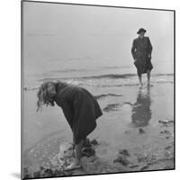 Girl Playing in the Sand while an Older Woman Gets Her Feet Wet in the Ocean at Blackpool Beach-Ian Smith-Mounted Photographic Print