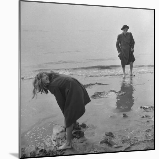 Girl Playing in the Sand while an Older Woman Gets Her Feet Wet in the Ocean at Blackpool Beach-Ian Smith-Mounted Photographic Print