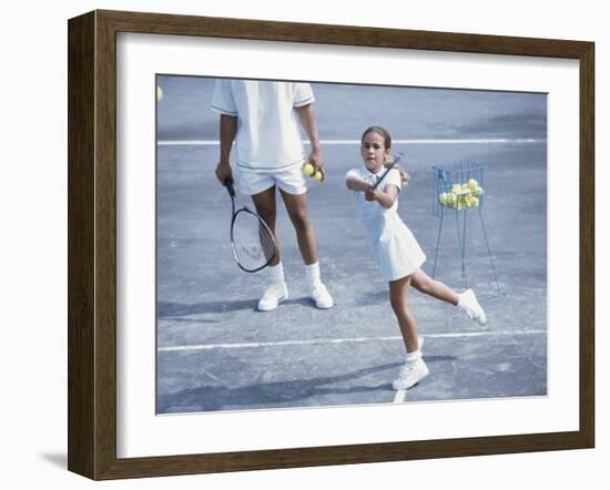 Girl Playing Tennis Under Supervision of a Coach-null-Framed Photographic Print