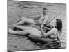 Girl Playing Violin For Boy as They Float on Inner Tube Sat Floating Party on the Apple River-Alfred Eisenstaedt-Mounted Photographic Print