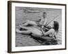 Girl Playing Violin For Boy as They Float on Inner Tube Sat Floating Party on the Apple River-Alfred Eisenstaedt-Framed Photographic Print
