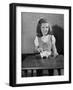 Girl Putting Money in Piggy Bank-Philip Gendreau-Framed Photographic Print