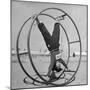 Girl Rolling in Large Wheel During Physical Education Class at North China Union University-George Lacks-Mounted Photographic Print