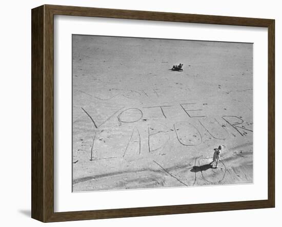 Girl Standing by the Words "Vote Labour" Written in the Sand-Cornell Capa-Framed Photographic Print