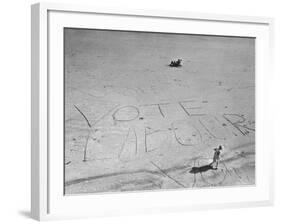 Girl Standing by the Words "Vote Labour" Written in the Sand-Cornell Capa-Framed Photographic Print