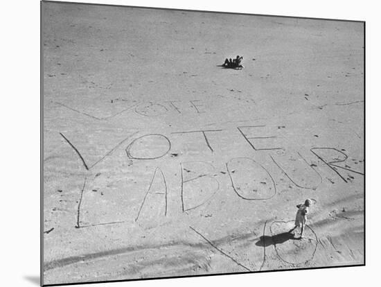 Girl Standing by the Words "Vote Labour" Written in the Sand-Cornell Capa-Mounted Photographic Print