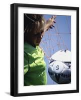 Girl Standing in a Goal Looking at a Soccer Ball-null-Framed Photographic Print