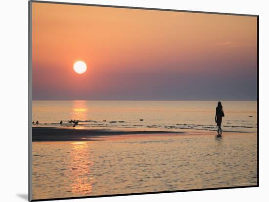 Girl Walking Barefoot on Beach at Sunset, Jurmala Beach Resort, Gulf of Riga, Latvia-Christian Kober-Mounted Photographic Print