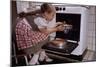 Girl Wearing Apron Removing Cakes from Oven-William P. Gottlieb-Mounted Photographic Print