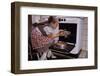 Girl Wearing Apron Removing Cakes from Oven-William P. Gottlieb-Framed Photographic Print