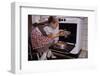 Girl Wearing Apron Removing Cakes from Oven-William P. Gottlieb-Framed Photographic Print