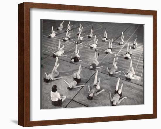 Girls and Women Doing Leg Exercise on Floor of Metropolitan Life Insurance Company's Gym-Herbert Gehr-Framed Photographic Print