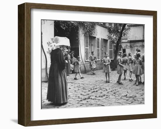 Girls Gathering in the Courtyard of the Mission, Nuns Nearby-null-Framed Photographic Print