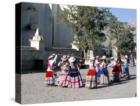 Girls in Traditional Local Dress Dancing in Square at Yanque Village, Colca Canyon, Peru-Tony Waltham-Stretched Canvas