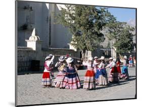 Girls in Traditional Local Dress Dancing in Square at Yanque Village, Colca Canyon, Peru-Tony Waltham-Mounted Photographic Print