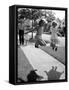 Girls on the street in neighborhood using rope to jump in tandem while man with toddler watches-Alfred Eisenstaedt-Framed Stretched Canvas