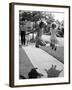 Girls on the street in neighborhood using rope to jump in tandem while man with toddler watches-Alfred Eisenstaedt-Framed Photographic Print