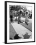 Girls on the street in neighborhood using rope to jump in tandem while man with toddler watches-Alfred Eisenstaedt-Framed Photographic Print