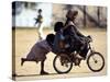 Girls Play on a Bike in Jammu, India-null-Stretched Canvas