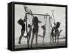 Girls Playing La Crosse on Beach-null-Framed Stretched Canvas