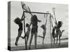 Girls Playing La Crosse on Beach-null-Stretched Canvas