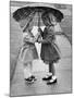 Girls Sharing an Umbrella-Josef Scaylea-Mounted Photographic Print