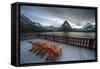 Glacier, Montana: Chairs Line the Deck of the Many Glacier Lodge During Sunset-Brad Beck-Framed Stretched Canvas