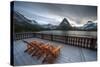 Glacier, Montana: Chairs Line the Deck of the Many Glacier Lodge During Sunset-Brad Beck-Stretched Canvas