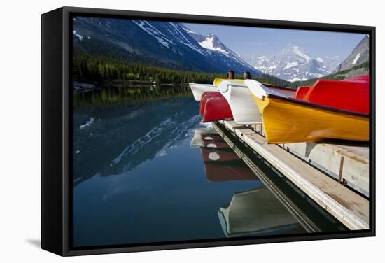 Glacier, Montana: Colorful Canoes Line the Dock at Many Glacier Lodge on Swiftcurrent Lake-Brad Beck-Framed Stretched Canvas